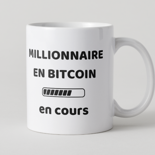 Mug blanc texte noir millionnaire en bitcoin  en cours avec barre de chargement.
